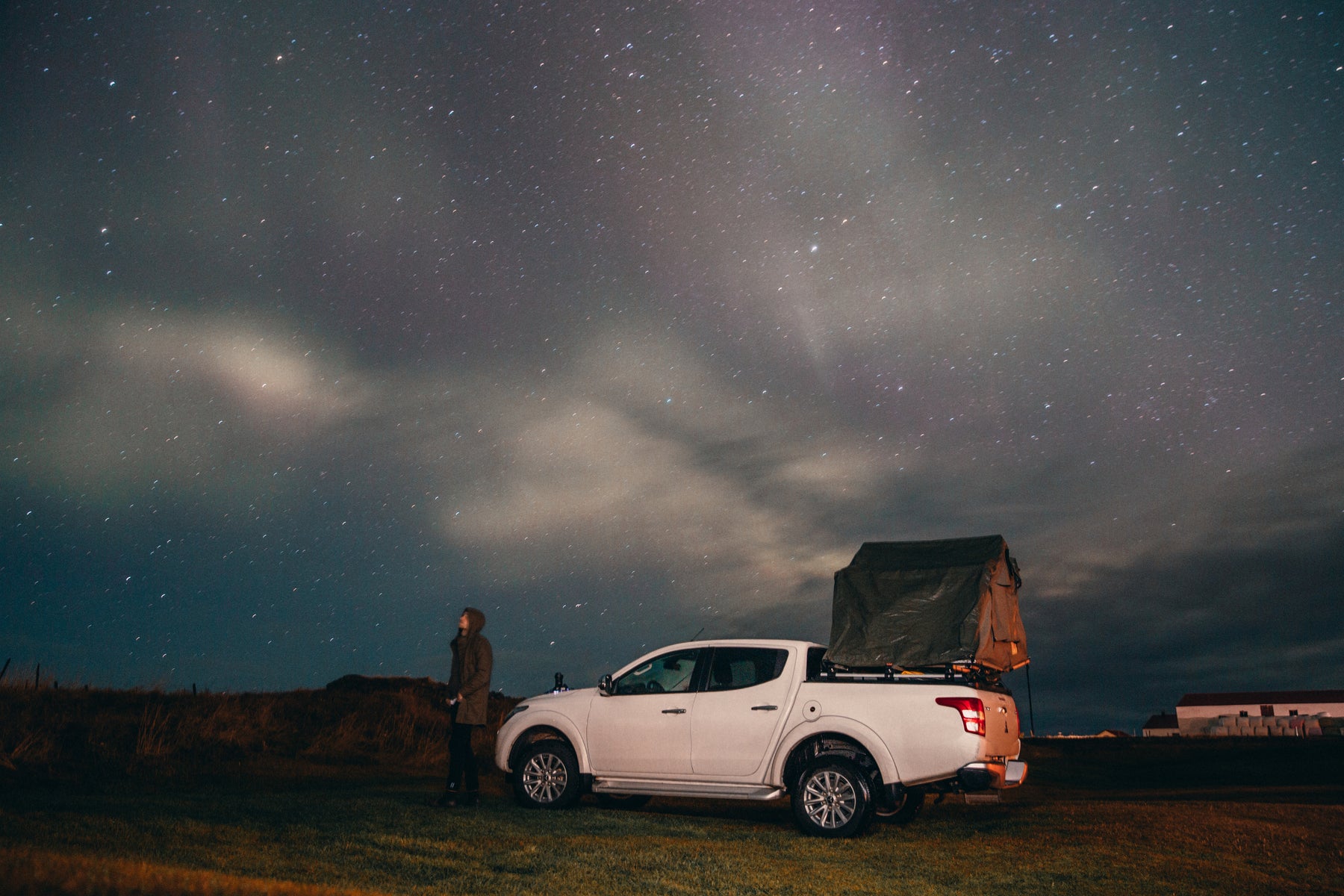 outdoor photo of a truck with a roof top tent at dusk.